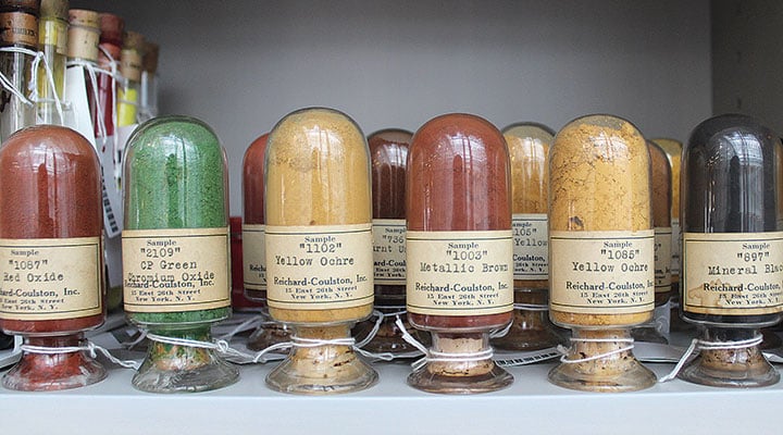 Several different pigment colors in glass jars.