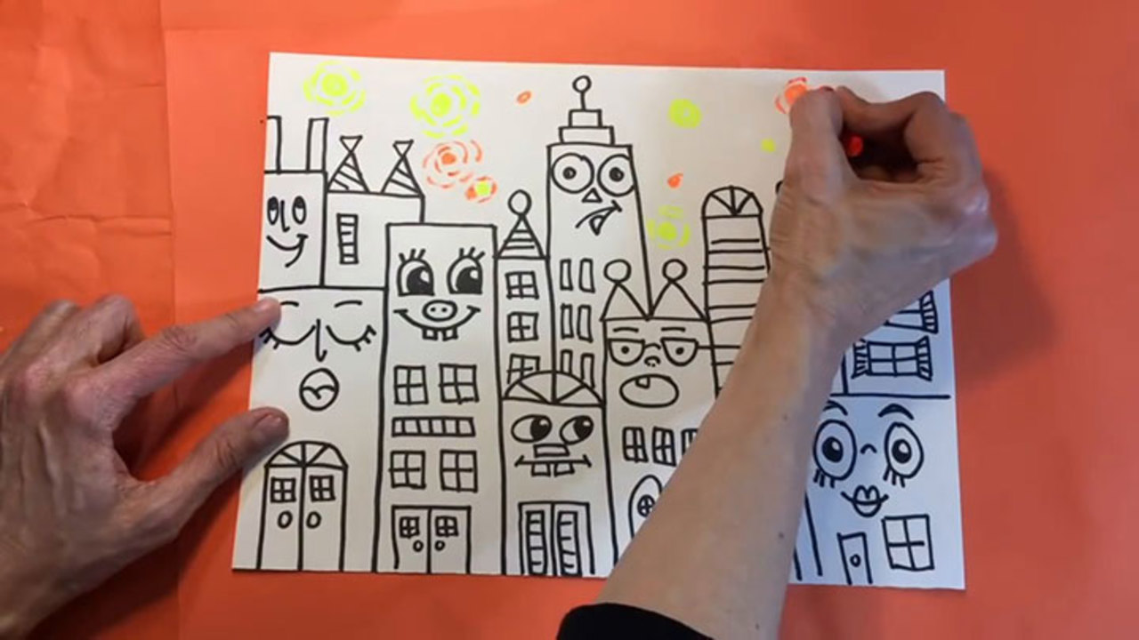 A screen grab of a YouTube video, where a woman&apos;s hands are drawing a skyline of smiling buildings