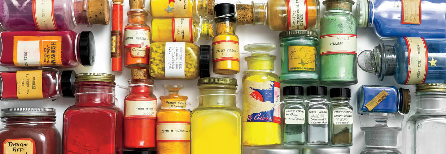 Image of a variety of different colored powders in glass bottles
